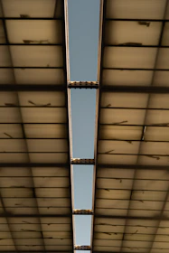 Close-up of a sturdy metal framework supporting a translucent polycarbonate roof.