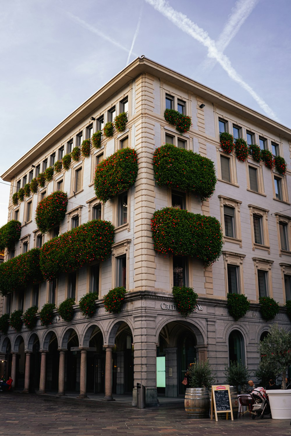 a large building with a bunch of plants on the side of it