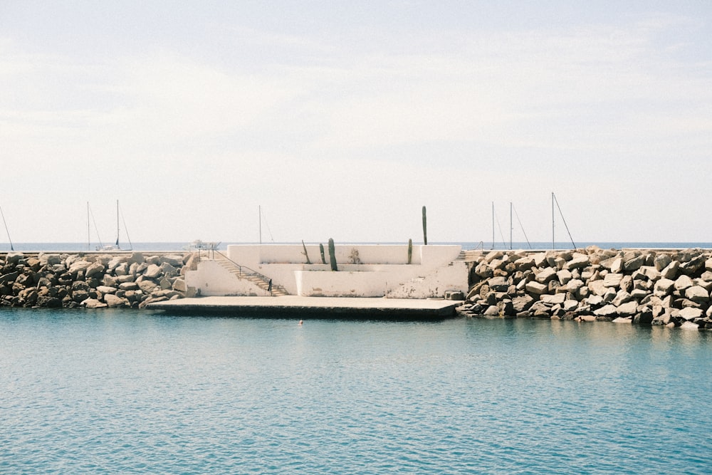 a concrete wall next to a body of water