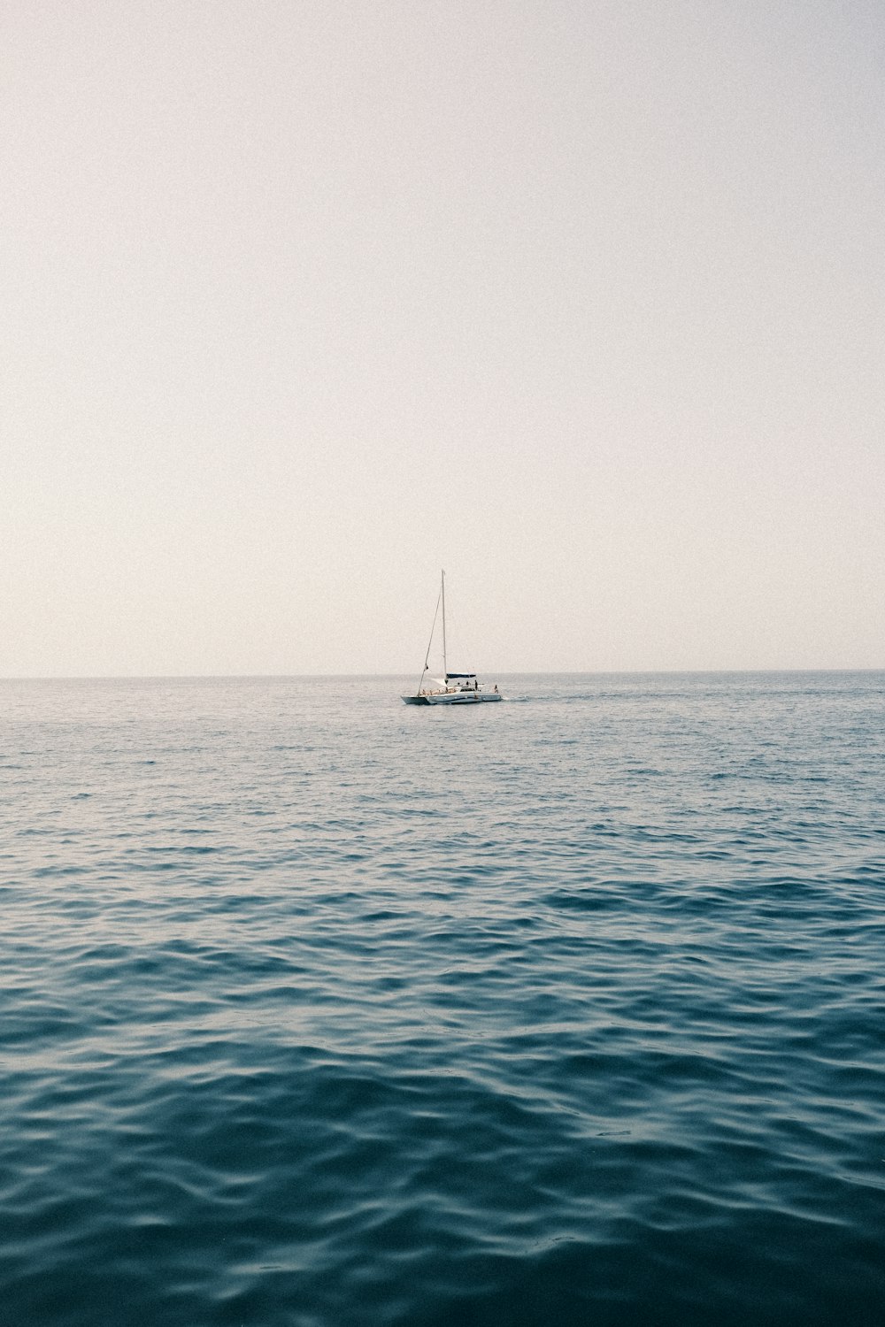 a sailboat in the middle of the ocean