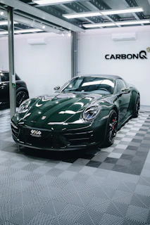 a green sports car parked in a garage