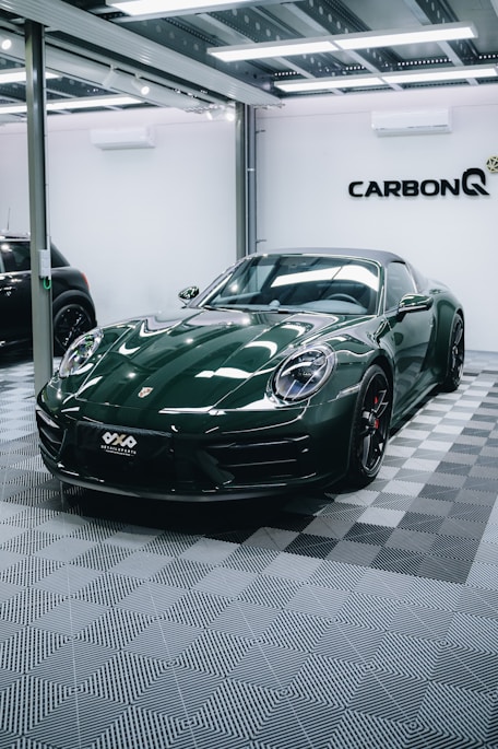 a green sports car parked in a garage