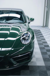a green sports car parked in a garage