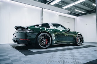 a green sports car parked in a garage