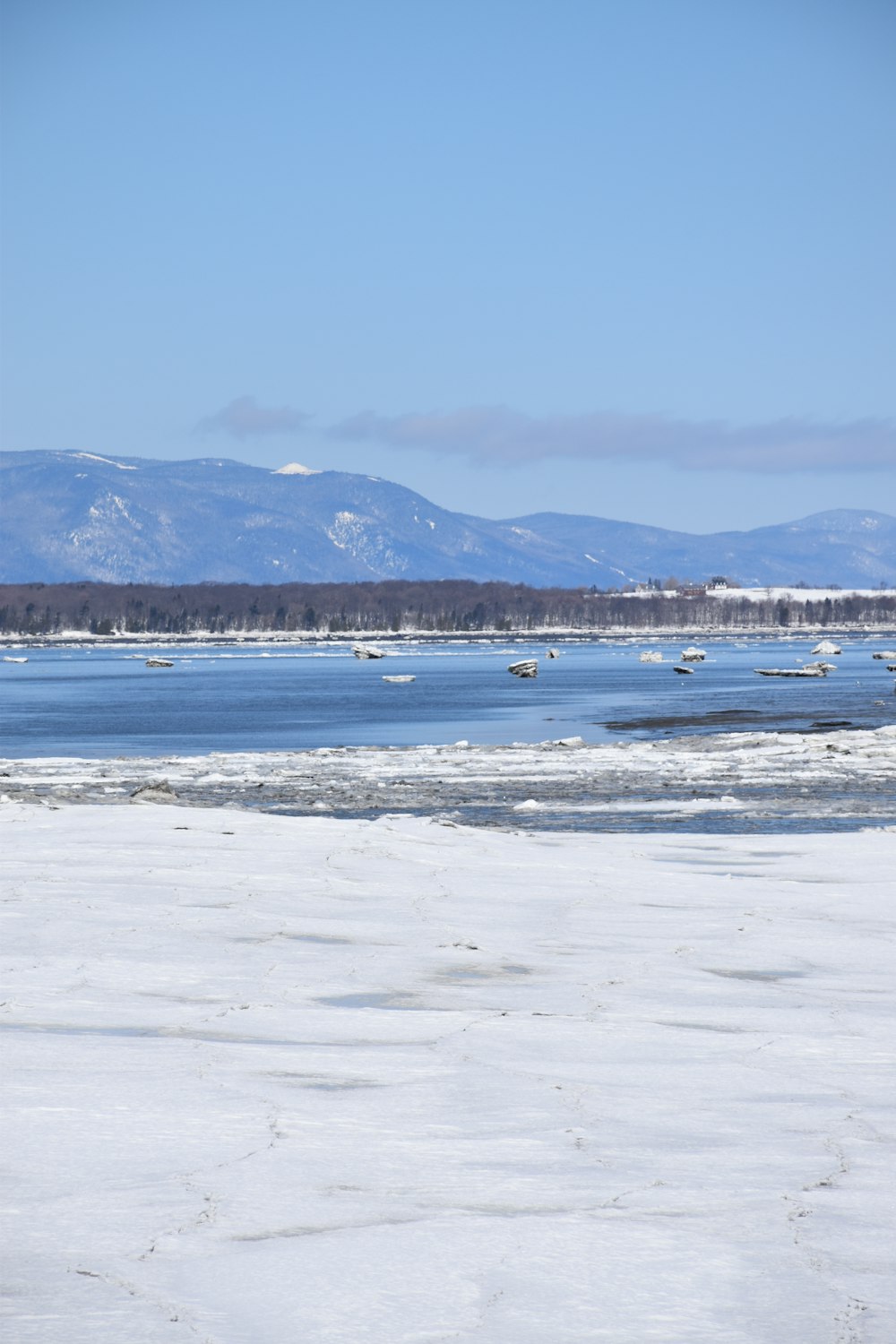 a large body of water with mountains in the background