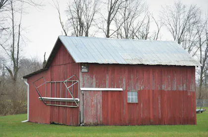 Faded red barn with a tin roof