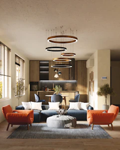 Modern living room renovation with navy blue and orange accents in a well-lit space.