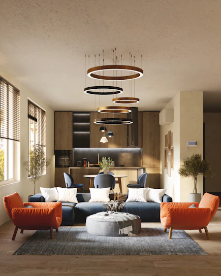 Modern living room renovation with navy blue and orange accents in a well-lit space.