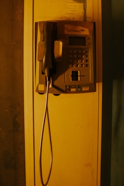 an old fashioned telephone with a cord attached to it