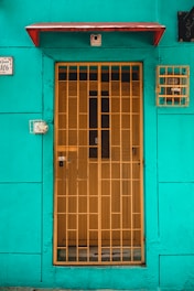 a blue building with a yellow door and window