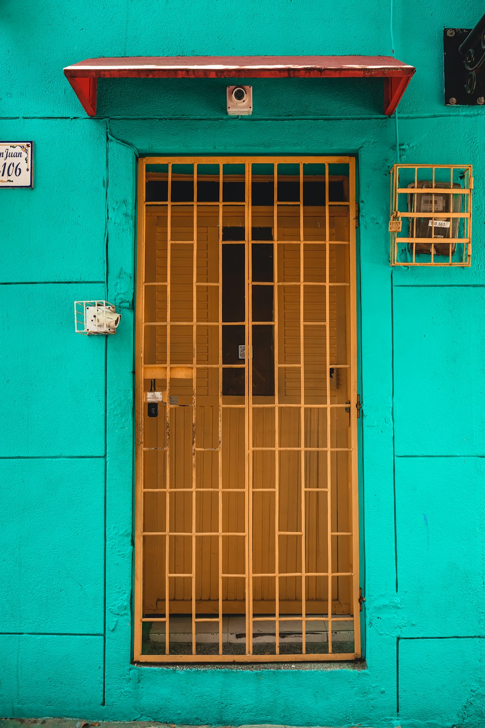 a blue building with a yellow door and window