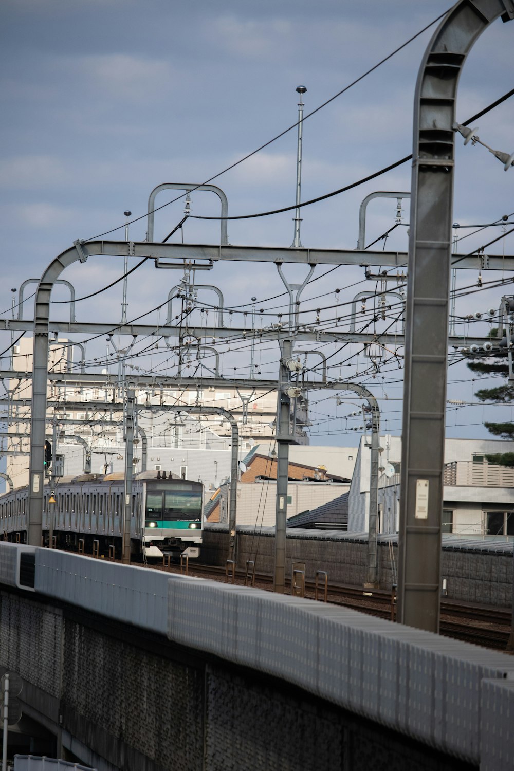 a train traveling down train tracks next to a building