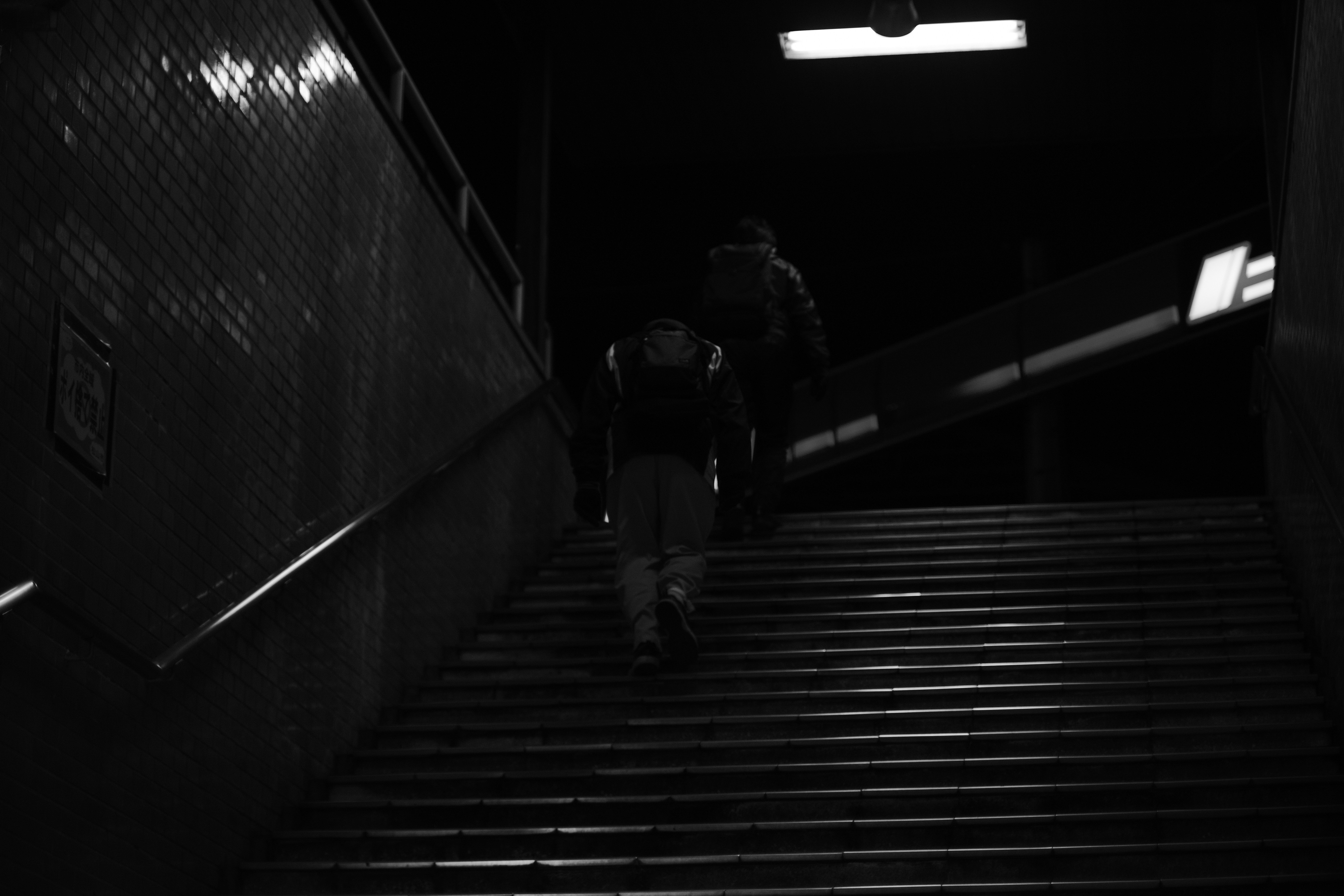 two people walking up a flight of stairs