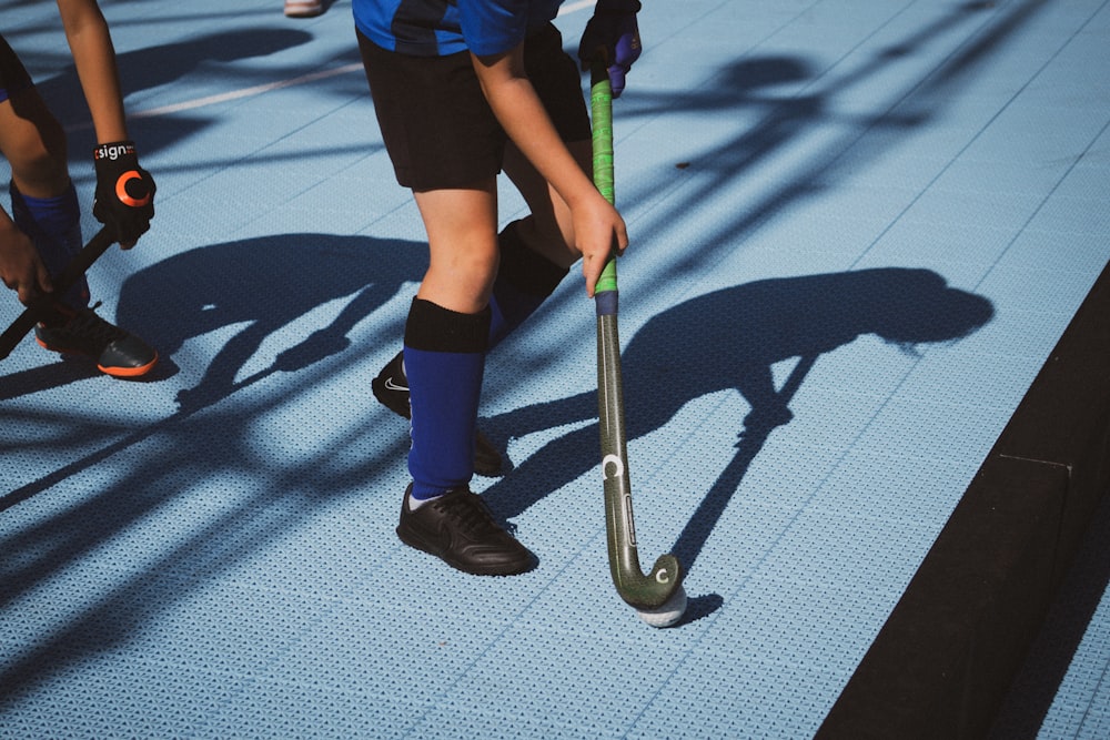 a group of young men playing a game of field hockey