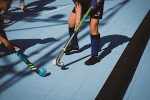 a group of young men playing a game of field hockey