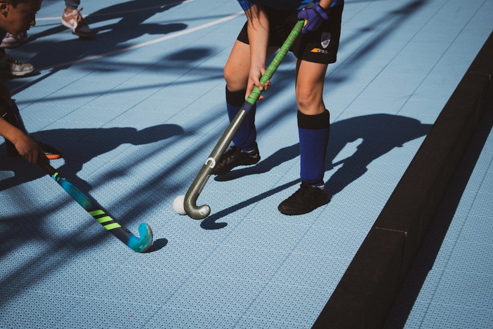 a group of young men playing a game of field hockey