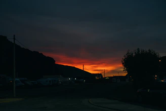 A gritty comic panel featuring a shadowy outlaw silhouetted against a blood-red sunset.