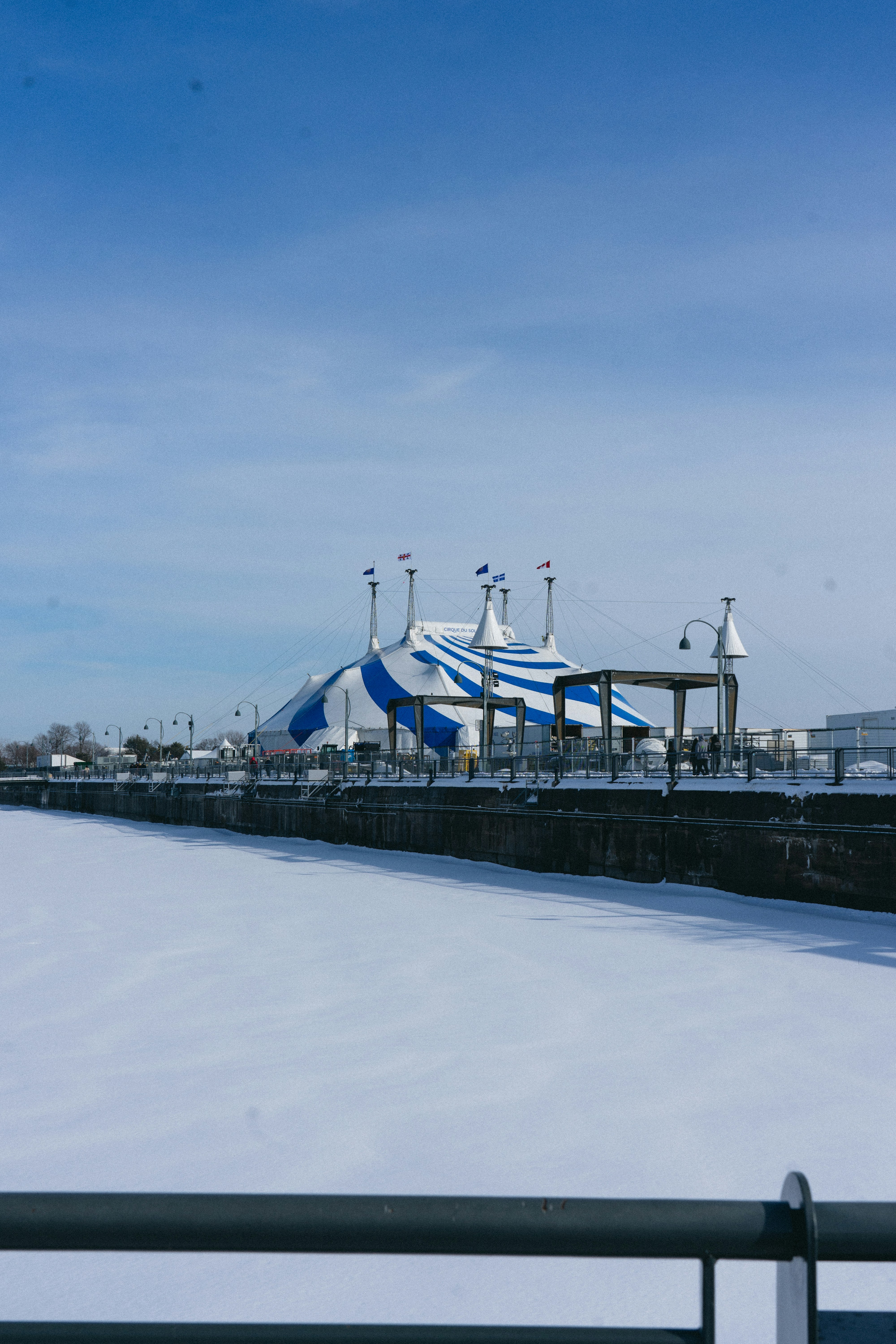 a view of a snow covered field with a building in the background