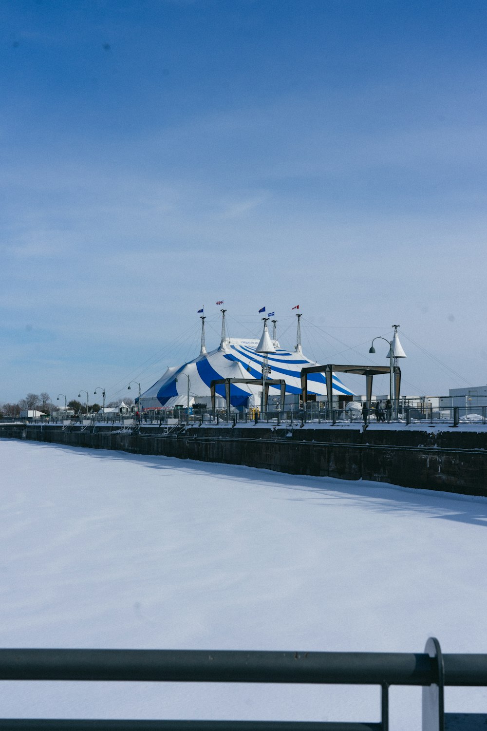 a view of a snow covered field with a building in the background