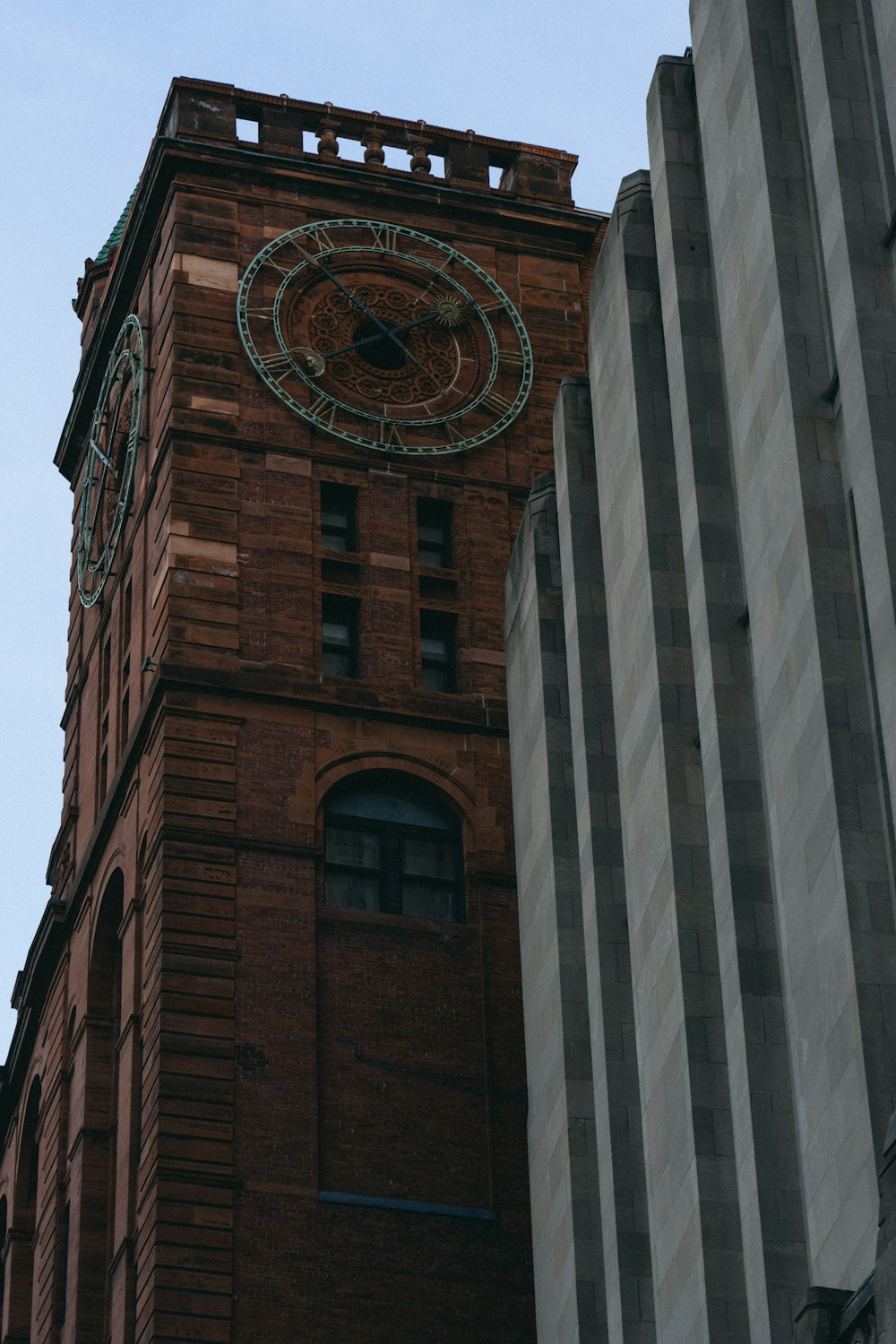 a tall brick building with a clock on it's face