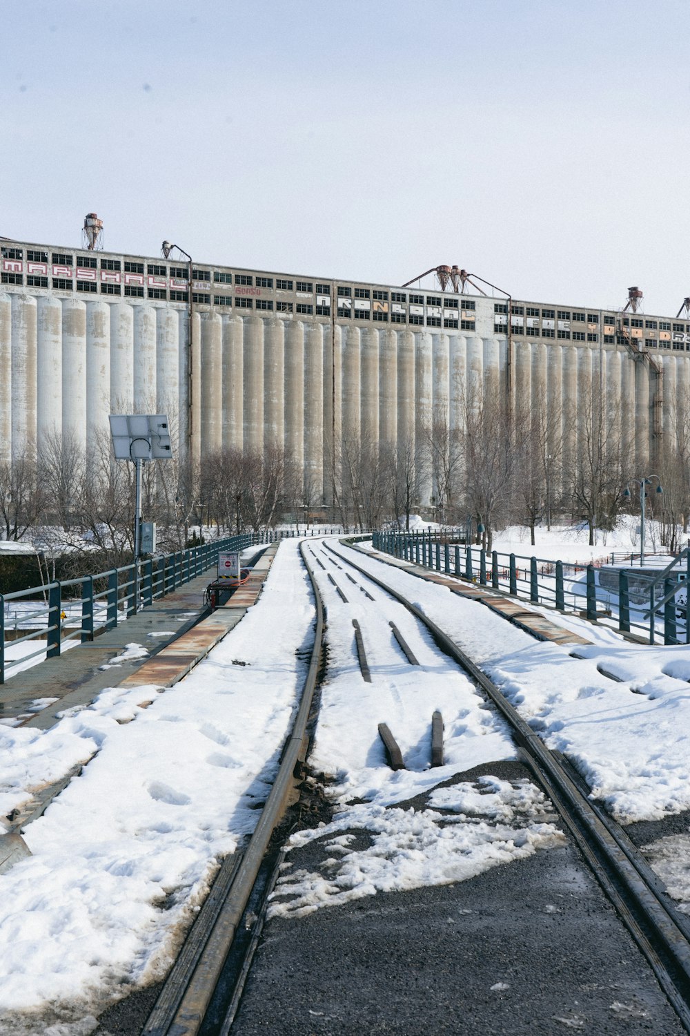 a train track with snow on the ground