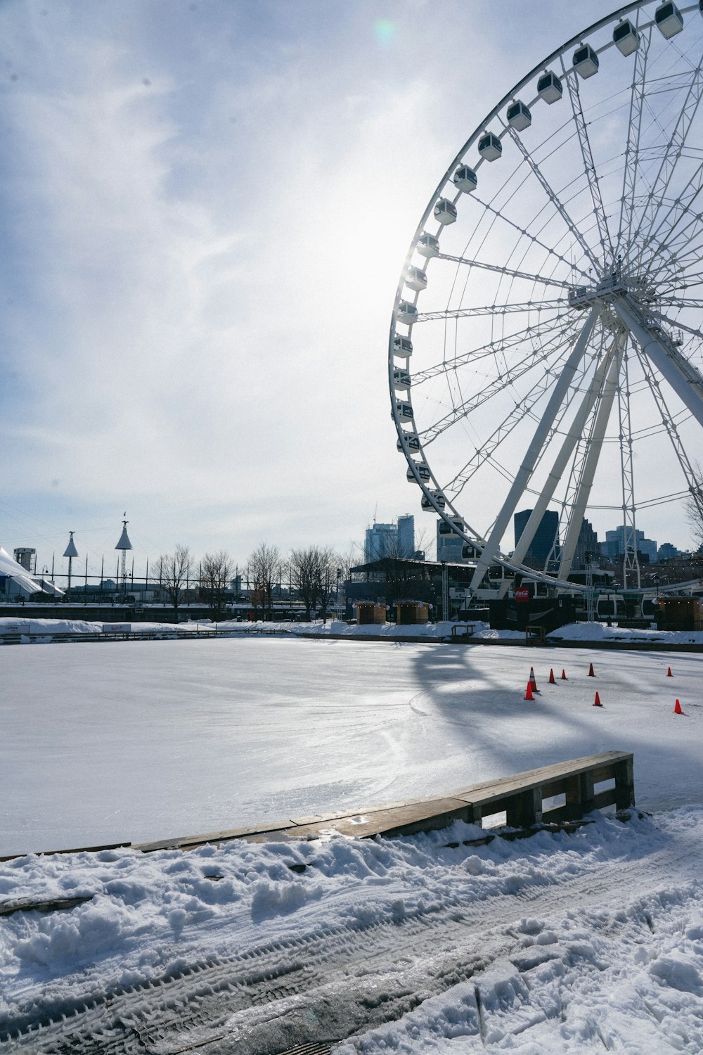 a large ferris wheel sitting on top of a snow covered field