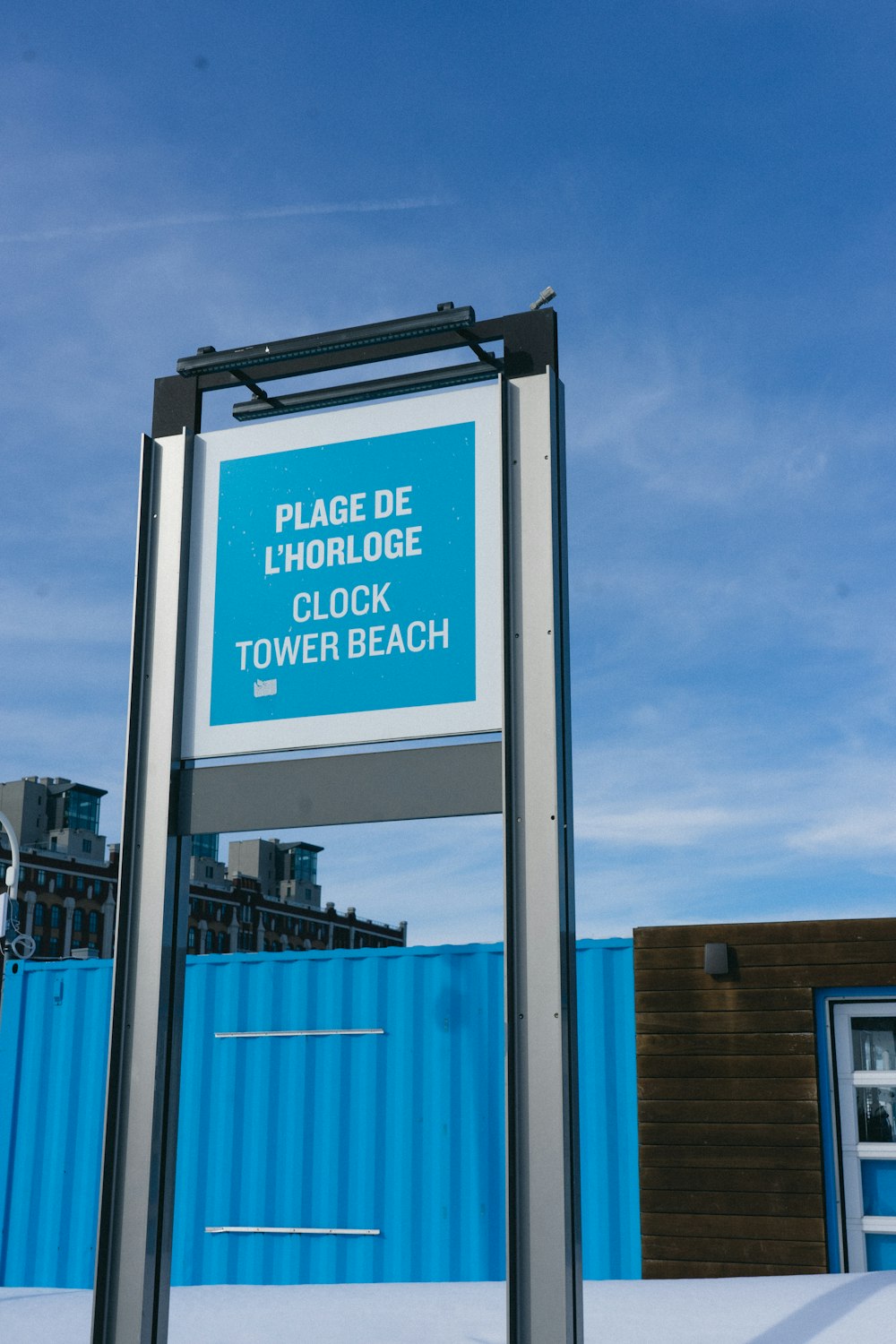 a sign in front of a blue building