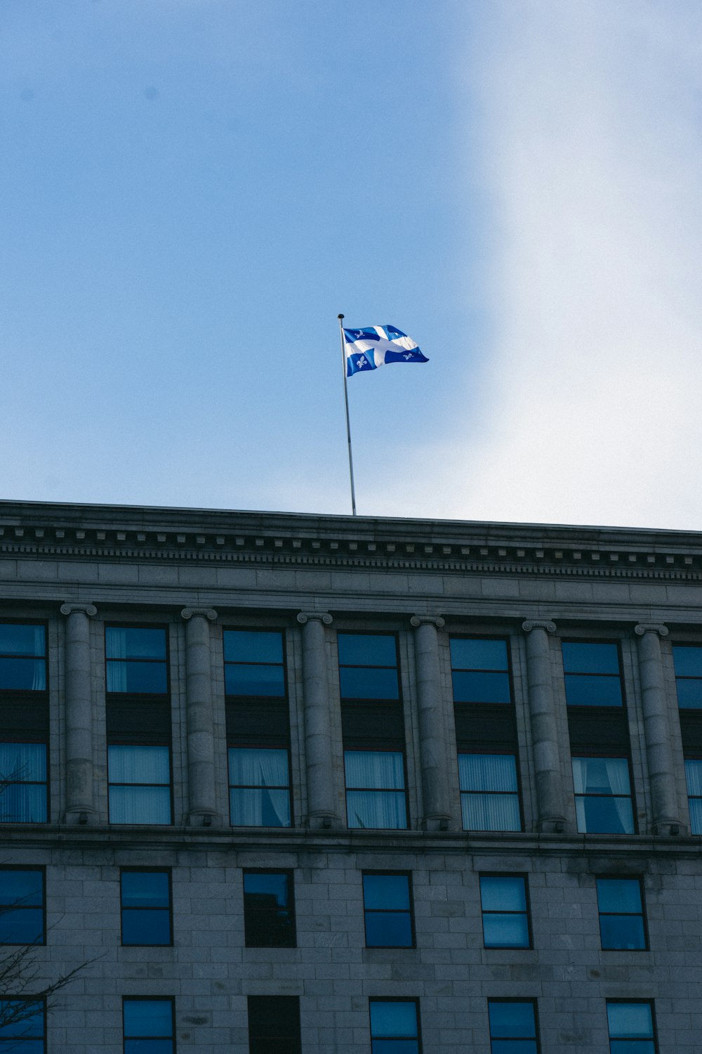 a flag flying on top of a tall building