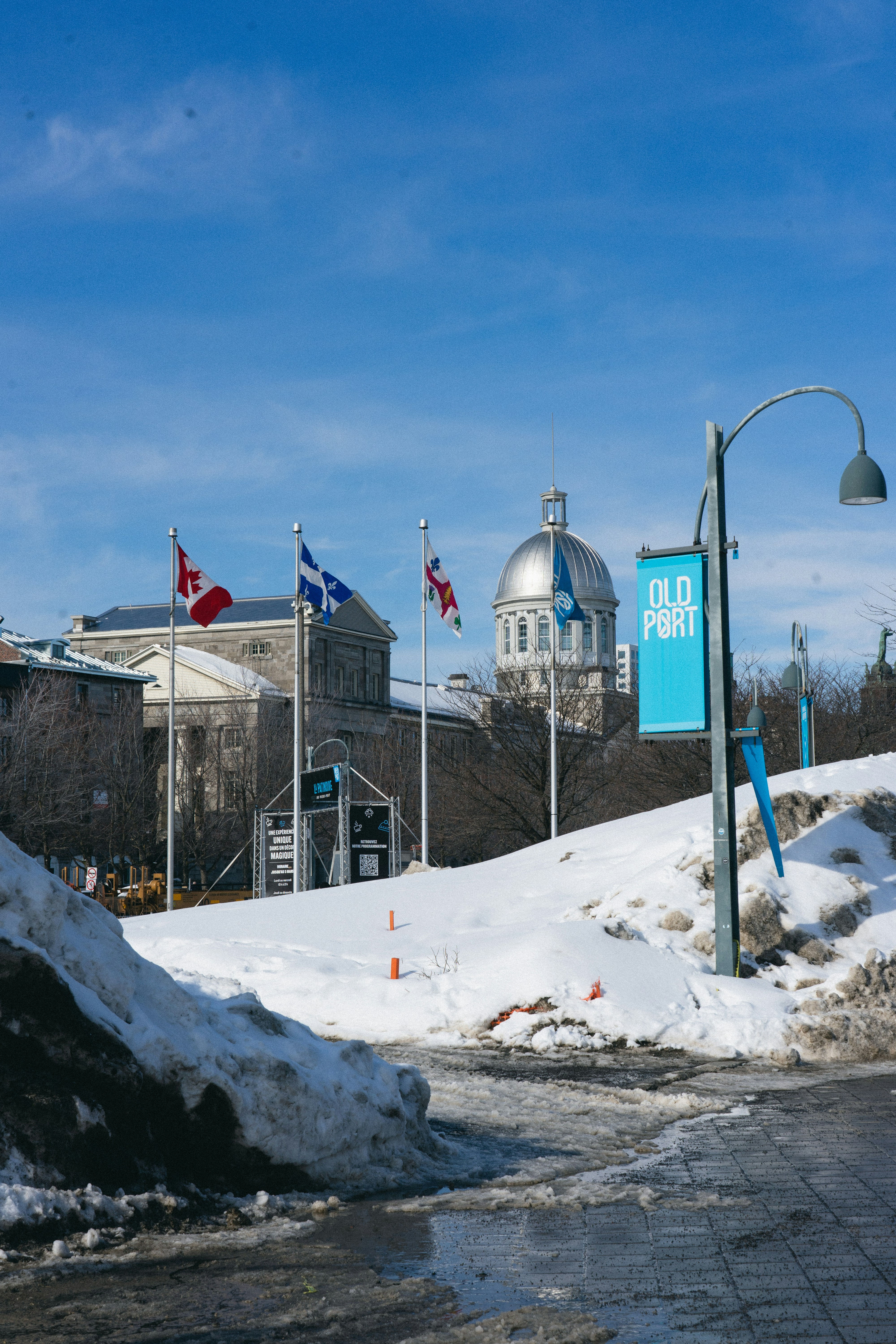 a street sign in front of a snow covered road