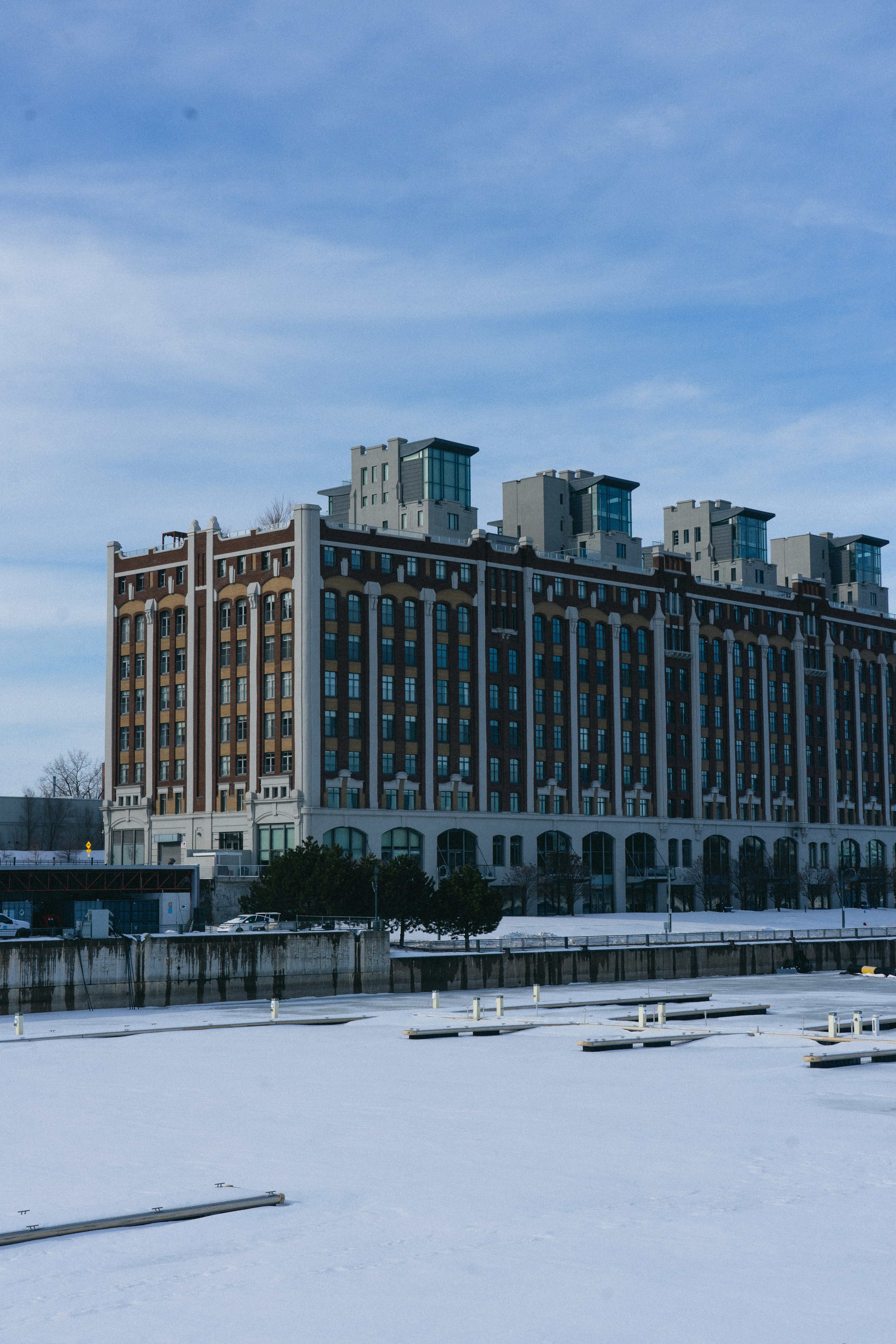 a very tall building sitting in the middle of a snow covered field