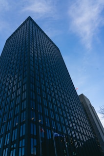 Government office building with flags and clear sky in daytime