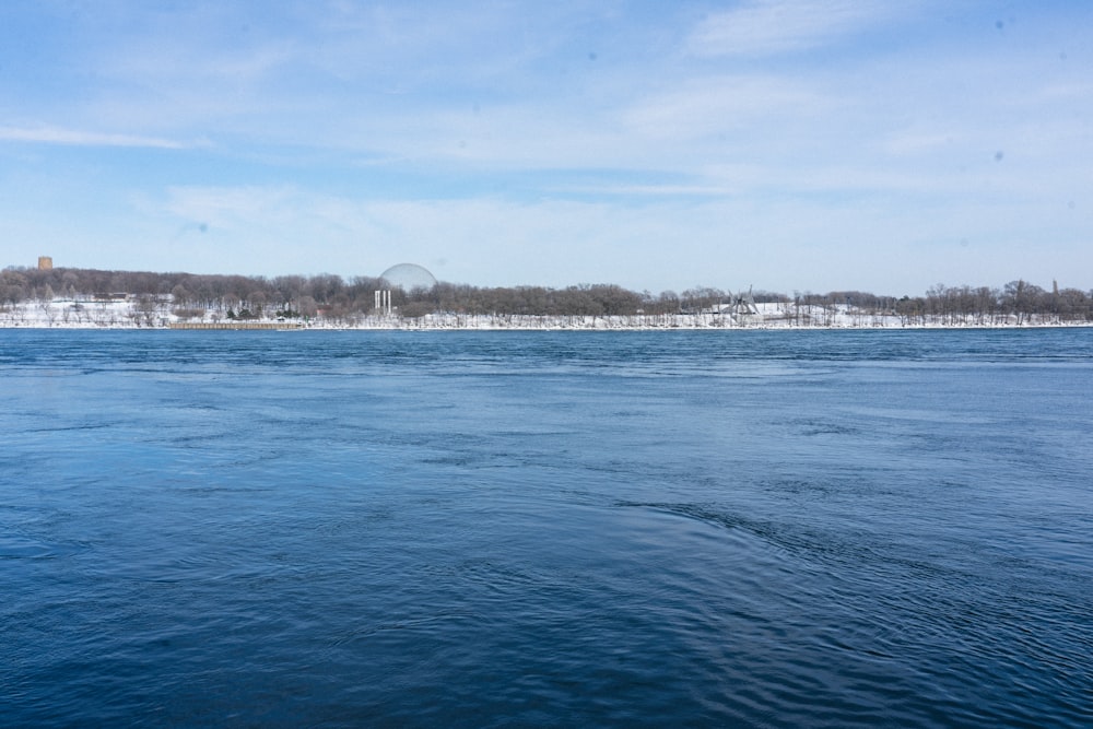 a body of water with trees in the background