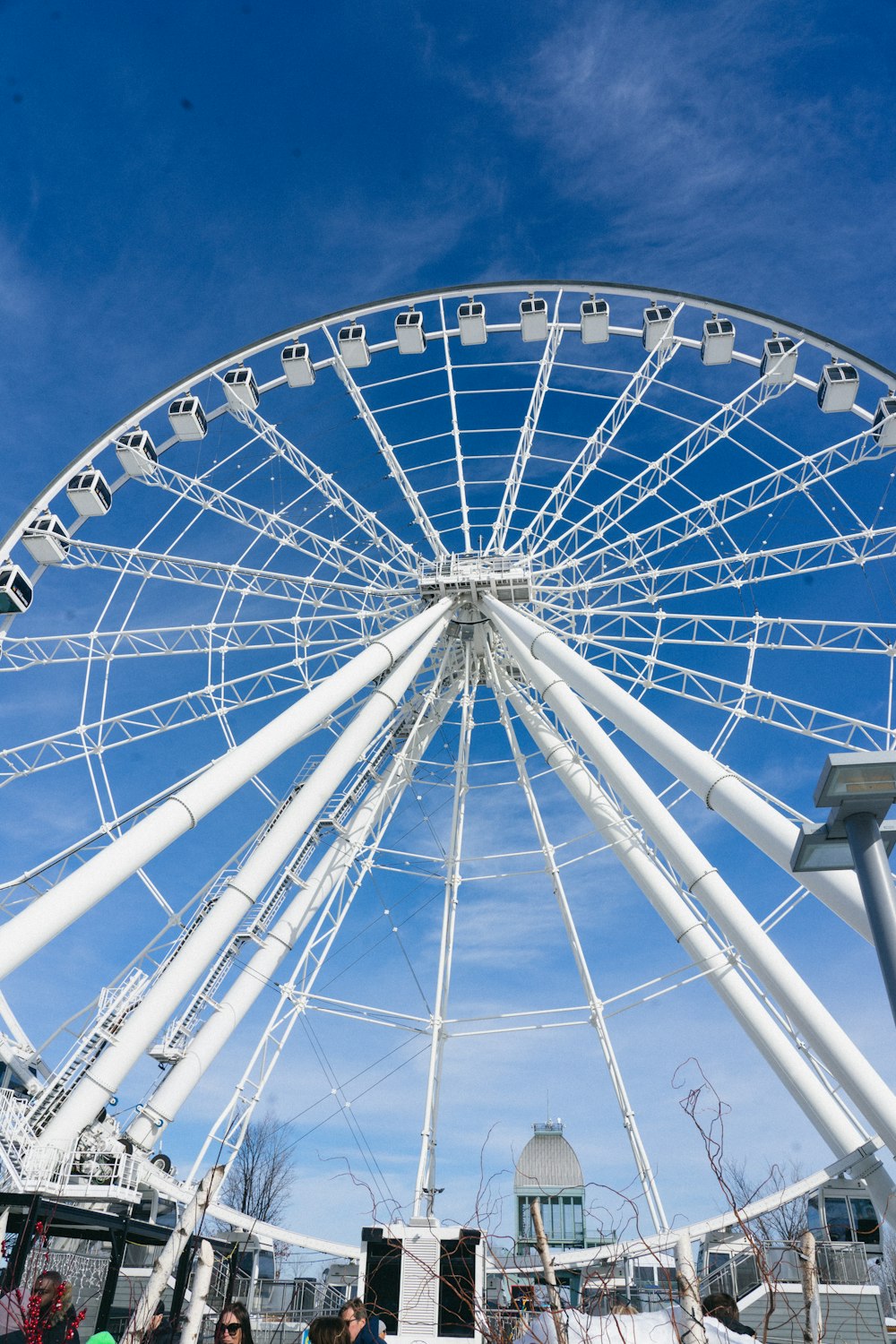 a large white ferris wheel on a sunny day