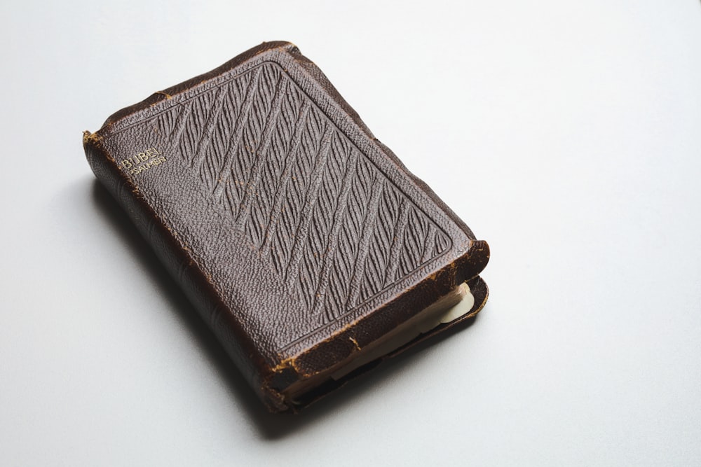 a brown leather book with a stitching pattern