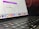 A close-up view of a MacBook Pro showing a section of the screen and keyboard. The screen displays a marketing offer for a subscription service with a limited launch special price. Various app icons are visible on the dock at the bottom of the screen.