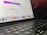 A close-up view of a MacBook Pro showing a section of the screen and keyboard. The screen displays a marketing offer for a subscription service with a limited launch special price. Various app icons are visible on the dock at the bottom of the screen.