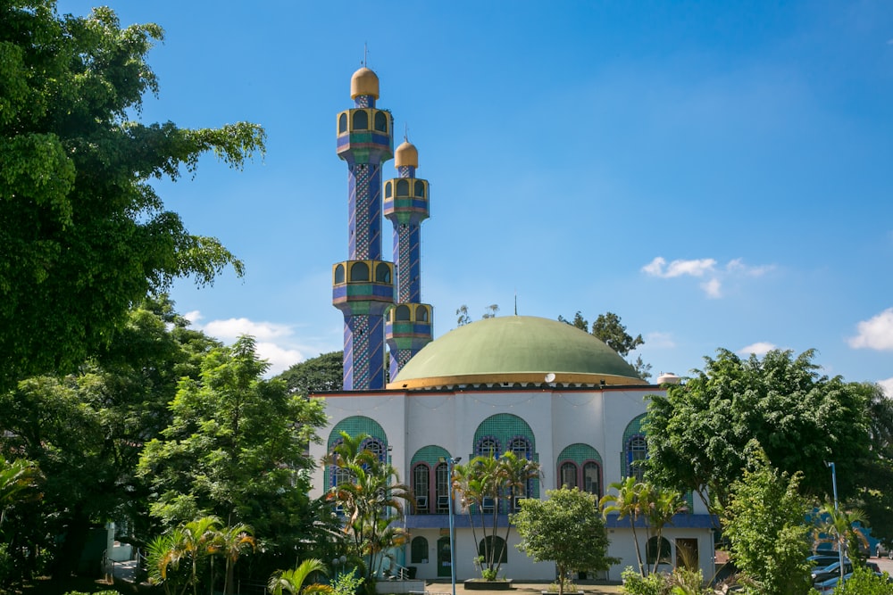 a large white building with a green dome