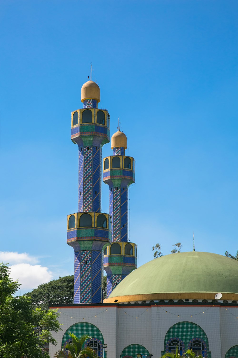 a large blue and yellow building with a green dome