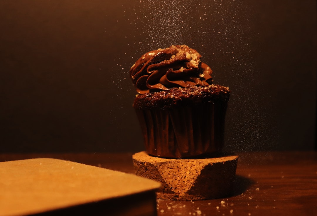 a chocolate cupcake with sprinkles on top of it