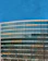 Close-up photo of a client smiling in front of a modern building model.