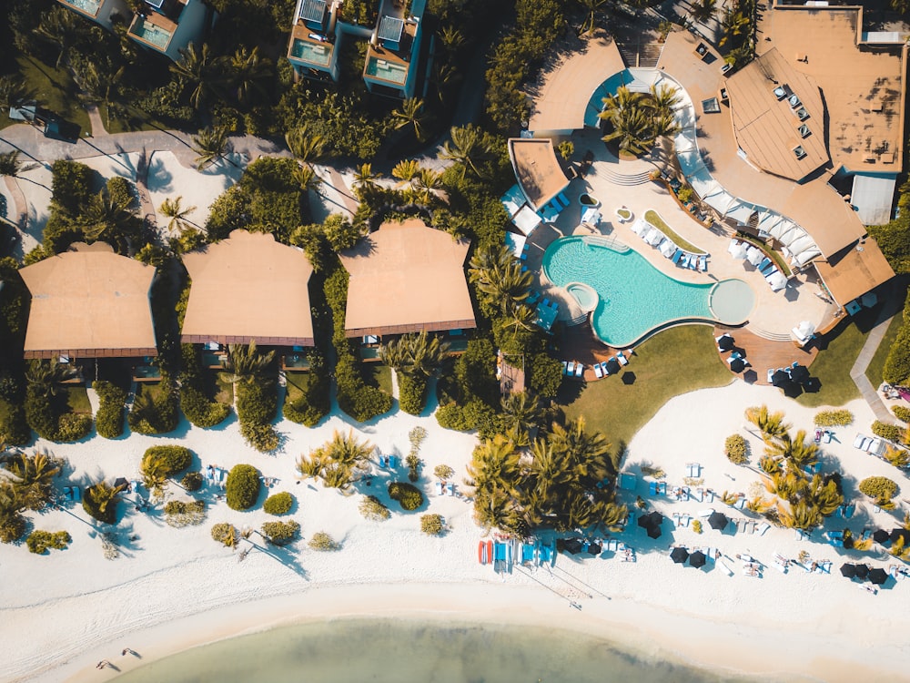 an aerial view of a resort with a swimming pool