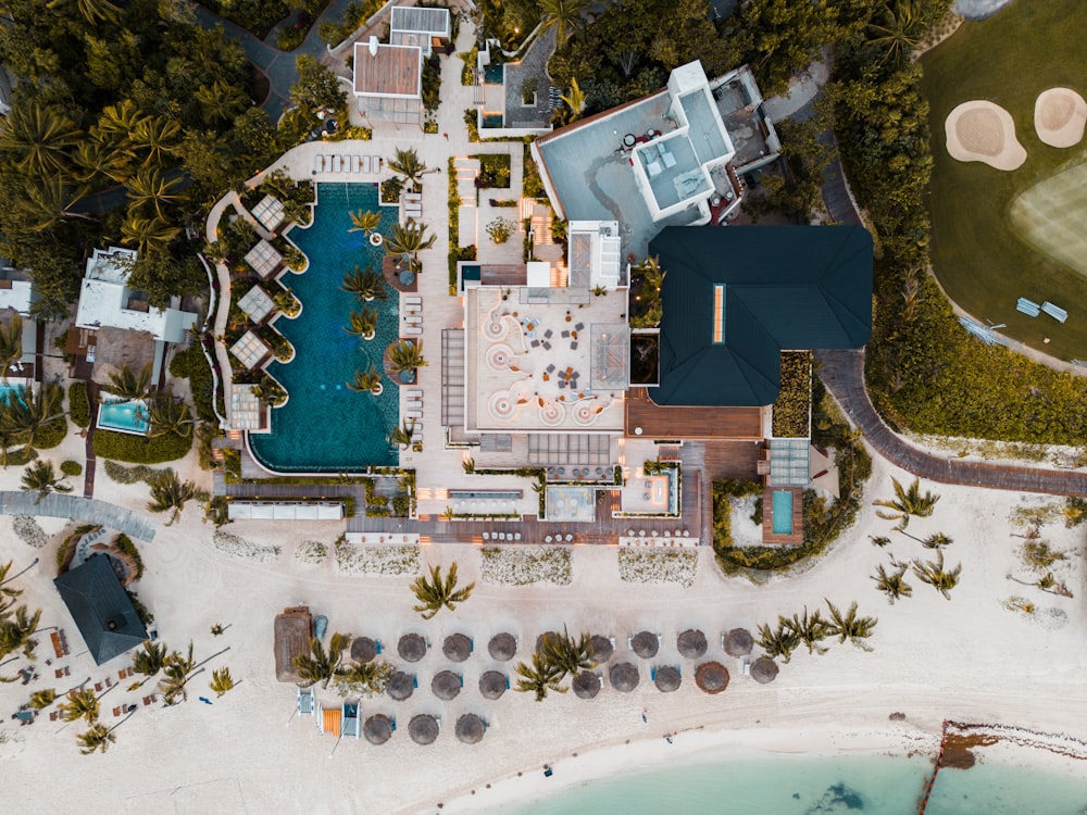 an aerial view of a resort with a swimming pool