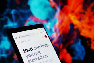 A smartphone screen displaying a web page from bard.google.com. The background is a vibrant and colorful abstract pattern, featuring swirling shapes in blue, red, and orange hues.