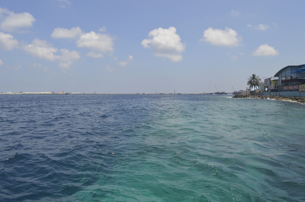 a body of water with houses in the distance