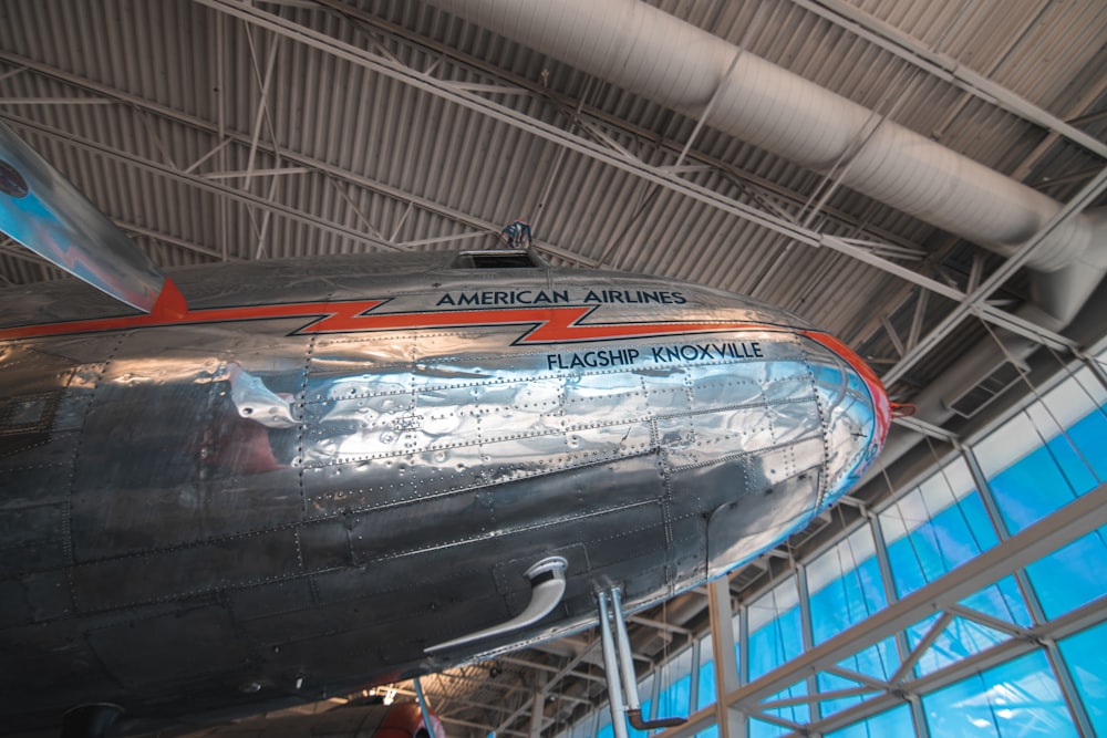 an airplane hanging from the ceiling of a building