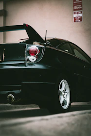 Rear view focusing on a diffuser and spoiler on a performance street vehicle.