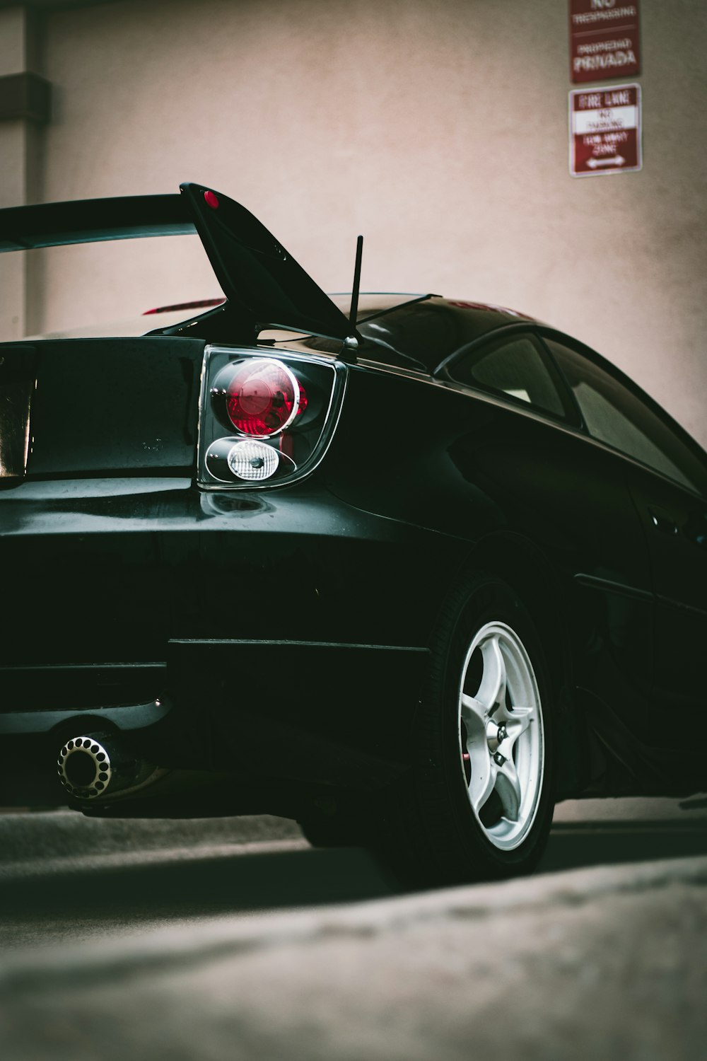 a black sports car parked in a parking garage