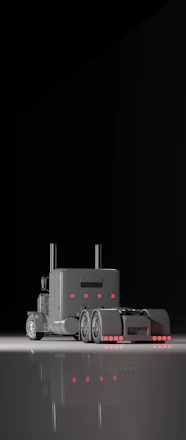 A sleek delivery truck loaded with various automobiles ready for distribution.