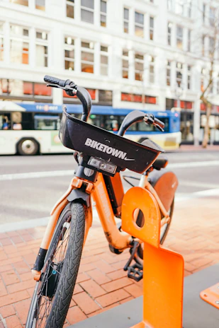 A happy customer unlocking an e-bike from a docking station near the Port Authority Bus Terminal.