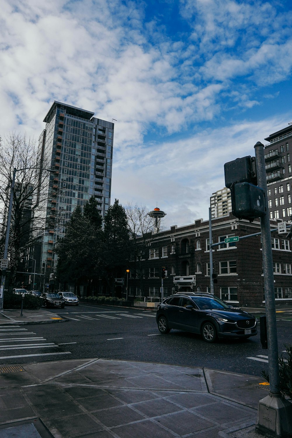 a city street with cars parked on the side of the road